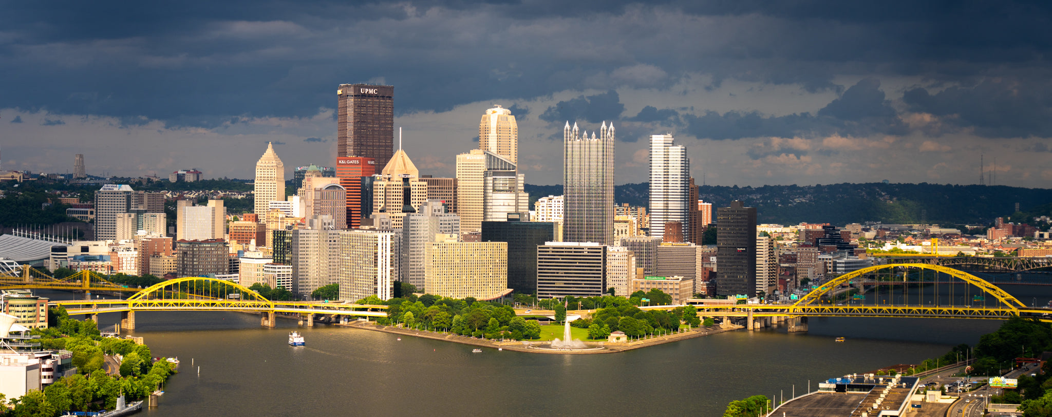 City skyline with a bridge over a river on a cloudy day