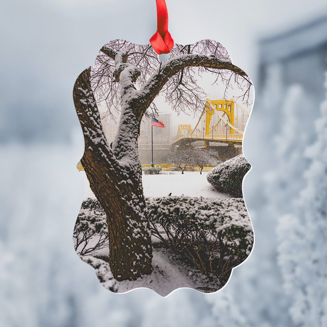 Snow Covered Tree Framing The Clemente Bridge Metal Christmas Ornament